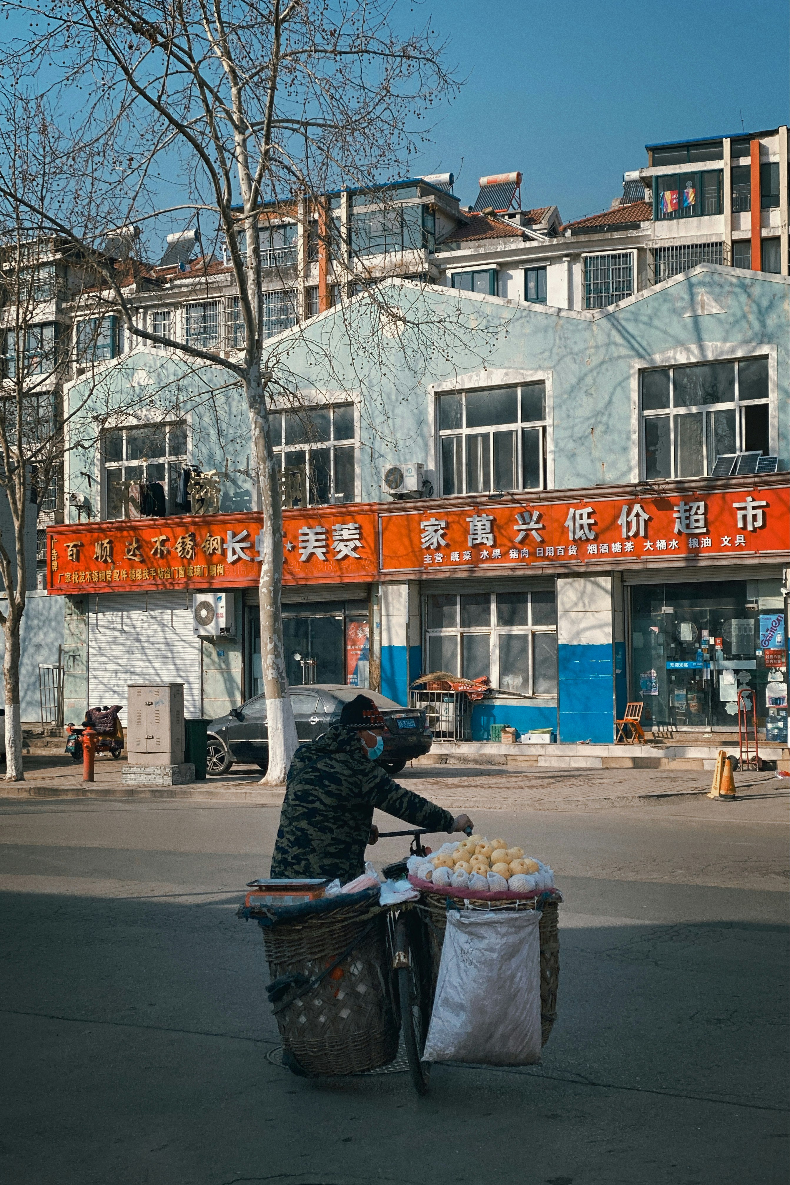 man in black jacket riding on black bicycle on road during daytime